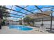 Screened-in pool area with in-ground pool, lounge chairs and lush landscaping at 12207 Shadowbrook Ln, Orlando, FL 32828