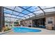 Screened-in pool area with in-ground pool, spa, and outdoor seating at 12207 Shadowbrook Ln, Orlando, FL 32828