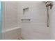Modern tiled shower stall with bench, niche, grab bar and adjustable shower head at 12207 Shadowbrook Ln, Orlando, FL 32828