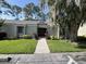 Condo with well-maintained landscaping and inviting walkway under a big tree at 124 Springwood Cir # B, Longwood, FL 32750