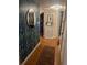 Hallway featuring hardwood floors, stylish wallpaper, and decorative accents at 124 Springwood Cir # B, Longwood, FL 32750