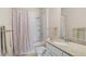 Well-lit bathroom with a shower-tub combination, granite countertop vanity, and neutral decor at 1300 Eastern Pecan Pl # 104, Winter Garden, FL 34787