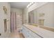 Bathroom featuring a granite countertop, a bathtub with shower and floral curtain at 1300 Eastern Pecan Pl # 104, Winter Garden, FL 34787