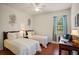 Inviting bedroom featuring two twin beds, a window, and a desk for a comfortable living space at 1300 Eastern Pecan Pl # 104, Winter Garden, FL 34787