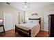 Bright bedroom featuring a wooden-framed bed, a window, and a closet with bi-fold doors at 1300 Eastern Pecan Pl # 104, Winter Garden, FL 34787