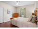 Bedroom showcasing hardwood floors, a ceiling fan, a dresser and queen size bed at 1300 Eastern Pecan Pl # 104, Winter Garden, FL 34787