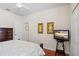 Comfortable bedroom has a decorative bed frame and a television on a wooden table at 1300 Eastern Pecan Pl # 104, Winter Garden, FL 34787
