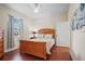 Bedroom with hardwood floors, ceiling fan, window with blinds, and a queen-sized bed at 1300 Eastern Pecan Pl # 104, Winter Garden, FL 34787