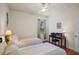 Comfortable bedroom features two twin beds, a window, and a desk with a laptop at 1300 Eastern Pecan Pl # 104, Winter Garden, FL 34787
