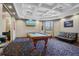 Resident billiards room is furnished with a pool table, leather sofa, TV and coffered ceilings at 1300 Eastern Pecan Pl # 104, Winter Garden, FL 34787