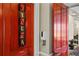 Entrance to resident cinema room features cinema signage on the red door and hand sanitizing station at 1300 Eastern Pecan Pl # 104, Winter Garden, FL 34787