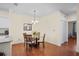Charming dining area features a glass table with seating for four under an elegant chandelier at 1300 Eastern Pecan Pl # 104, Winter Garden, FL 34787