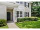Charming townhome exterior with dark green door and tidy landscaping at 1300 Eastern Pecan Pl # 104, Winter Garden, FL 34787