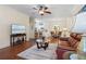 Cozy living room open to dining and kitchen area, featuring hardwood floors at 1300 Eastern Pecan Pl # 104, Winter Garden, FL 34787