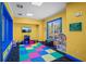 Colorful playroom with a play structure, soft block play area, and small table with chairs at 1300 Eastern Pecan Pl # 104, Winter Garden, FL 34787