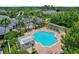 Aerial view of the large community pool with surrounding pergolas, landscaping, and lounge seating at 1300 Eastern Pecan Pl # 104, Winter Garden, FL 34787