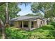 Backyard featuring a covered patio, mature trees and well-maintained lawn for outdoor enjoyment at 1354 Dutch Elm Dr, Altamonte Springs, FL 32714