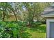Lush backyard with mature trees and landscaping creating a private and serene outdoor space at 1354 Dutch Elm Dr, Altamonte Springs, FL 32714