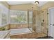 Well lit bathroom with a tiled shower and separate soaking tub beneath a window at 1354 Dutch Elm Dr, Altamonte Springs, FL 32714