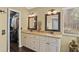 Bathroom featuring dual sinks, a window that provides natural light, and a doorway to a walk-in closet at 1354 Dutch Elm Dr, Altamonte Springs, FL 32714
