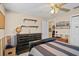 Bedroom featuring tan walls, ceiling fan, and a dark wooden dresser at 1354 Dutch Elm Dr, Altamonte Springs, FL 32714