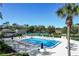 Community pool area surrounded by mature trees, with a clubhouse and tennis courts in background at 1354 Dutch Elm Dr, Altamonte Springs, FL 32714