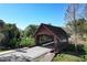 A charming covered bridge adds character to the community amidst lush greenery and clear blue skies at 1354 Dutch Elm Dr, Altamonte Springs, FL 32714