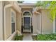 Inviting front entrance featuring a dark-colored front door and elegant decorative plants at 1354 Dutch Elm Dr, Altamonte Springs, FL 32714