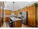 Spacious kitchen with granite countertops, wood cabinets, a large island, and stainless steel appliances at 1354 Dutch Elm Dr, Altamonte Springs, FL 32714
