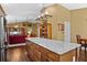 Open-concept kitchen with a large island, granite countertops, wooden cabinets, and stainless steel appliances at 1354 Dutch Elm Dr, Altamonte Springs, FL 32714