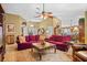 Spacious living room featuring comfortable seating arrangement, ceiling fan, and neutral carpet with decorative rug at 1354 Dutch Elm Dr, Altamonte Springs, FL 32714