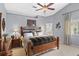 Relaxing main bedroom with warm tones, featuring a ceiling fan, large windows, and a comfortable seating area at 1354 Dutch Elm Dr, Altamonte Springs, FL 32714
