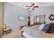 Cozy main bedroom with plush bedding, ceiling fan, and an ensuite bathroom providing a private retreat at 1354 Dutch Elm Dr, Altamonte Springs, FL 32714