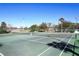 Outdoor tennis courts with green surface, nets, and surrounding landscaping offer a great recreational amenity at 1354 Dutch Elm Dr, Altamonte Springs, FL 32714