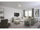 Bright and airy living room with neutral tones, modern furnishings, and plenty of natural light at 1397 Dalkeith Cv, Sanford, FL 32771