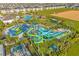 An aerial view shows a community water park and pool, offering fun recreational opportunities at 1421 Wexford Way, Davenport, FL 33896