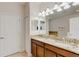 Spacious bathroom with a double vanity, granite countertop, and ample lighting at 1421 Wexford Way, Davenport, FL 33896