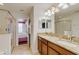 Well-lit bathroom featuring double vanity, granite countertops, and walk-in shower at 1421 Wexford Way, Davenport, FL 33896