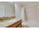 Bright bathroom with a shower-tub combo and granite-look vanity at 1421 Wexford Way, Davenport, FL 33896