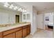 Bathroom featuring a double-sink vanity with stone countertop and wood cabinets at 1421 Wexford Way, Davenport, FL 33896