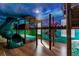 Themed bedroom with custom bunk beds, slide, ladder, and vibrant wall art creating a playful and imaginative space at 1421 Wexford Way, Davenport, FL 33896
