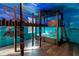 Themed bedroom with custom bunk beds, intricate woodwork, and vibrant wall art creating a playful and imaginative space at 1421 Wexford Way, Davenport, FL 33896