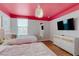 Colorful bedroom featuring two twin beds, bright ceiling, and modern accents at 1421 Wexford Way, Davenport, FL 33896