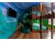 Themed bedroom with custom bunk beds, slide, and wall art creating a playful and imaginative space at 1421 Wexford Way, Davenport, FL 33896