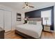 Cozy bedroom with comfortable bed, elegant headboard, and dark accent wall at 1421 Wexford Way, Davenport, FL 33896