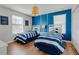 Charming bedroom with two twin beds, blue accents, and bright, natural light at 1421 Wexford Way, Davenport, FL 33896