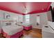 Vibrant bedroom featuring two twin beds, colorful ceiling, and modern furnishings at 1421 Wexford Way, Davenport, FL 33896