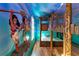 Themed bedroom with custom bunk beds, intricate woodwork, and vibrant wall art creating a playful and imaginative space at 1421 Wexford Way, Davenport, FL 33896