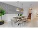 Well-lit dining area featuring a stylish accent wall and modern pendant lighting at 1421 Wexford Way, Davenport, FL 33896