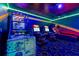 The game room features arcade games, unique carpeting, and distinctive lighting, offering an exciting recreational space at 1421 Wexford Way, Davenport, FL 33896